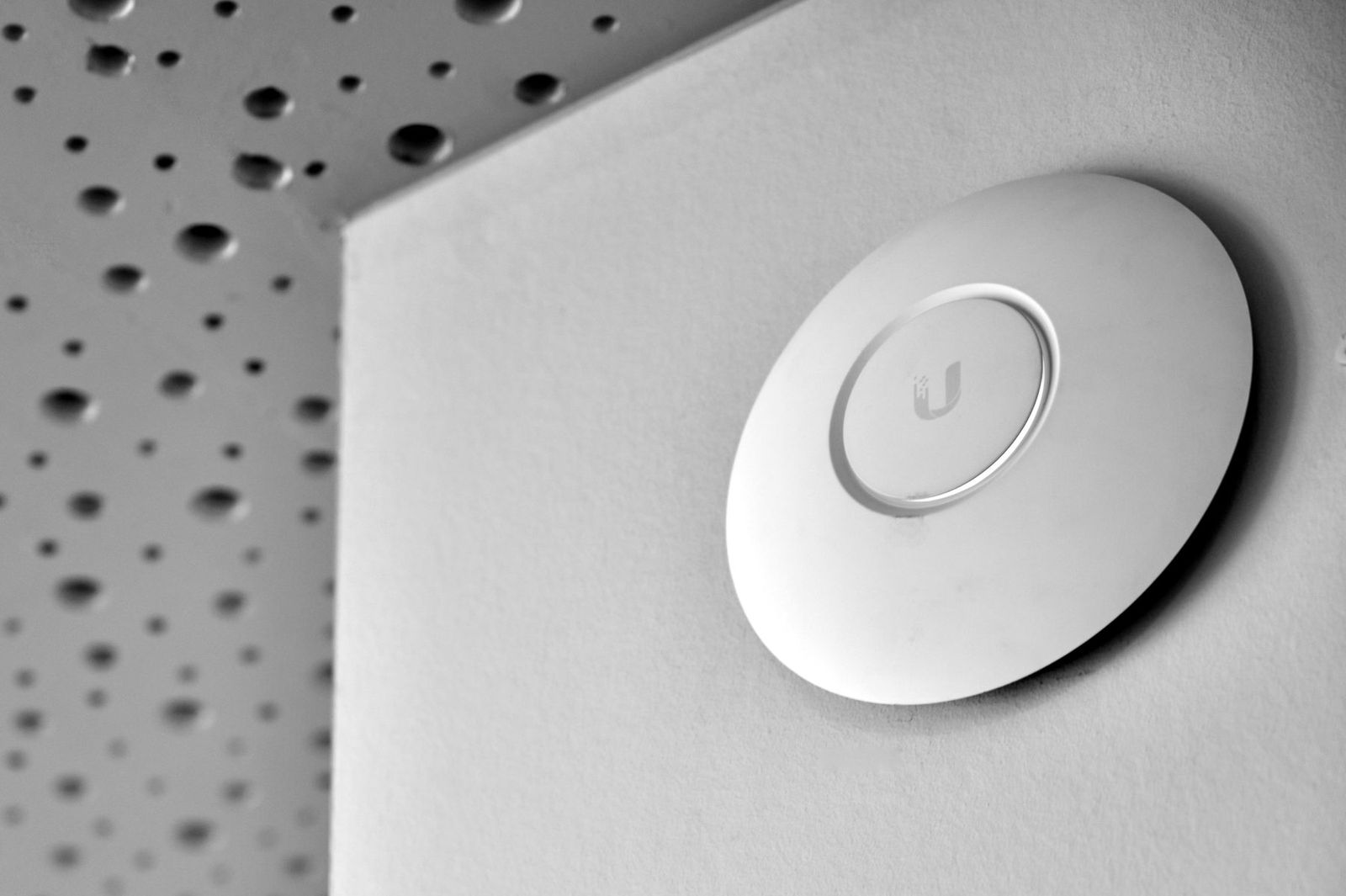 WiFi access point glowing on a ceiling