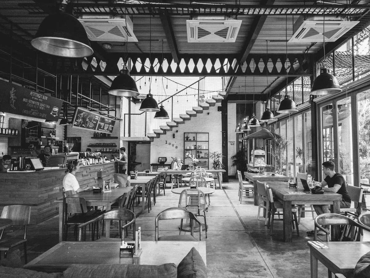 Busy café interior with people working on laptops