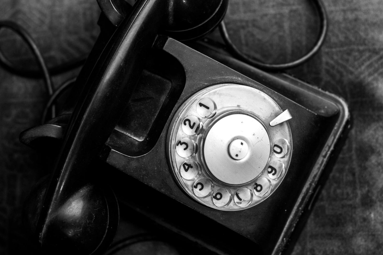 Black rotary telephone seen from above